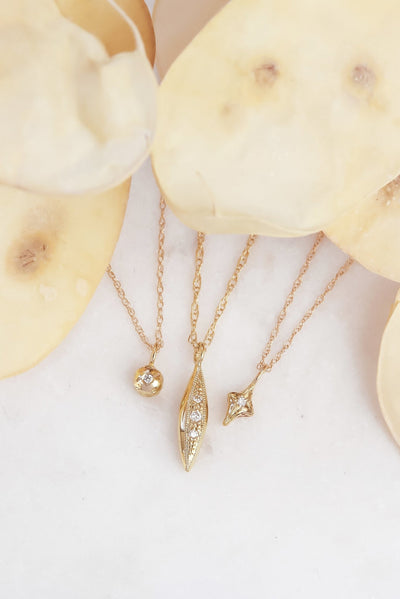 Delicate Diamond Charm Necklaces Layered To Make a Style Statement
